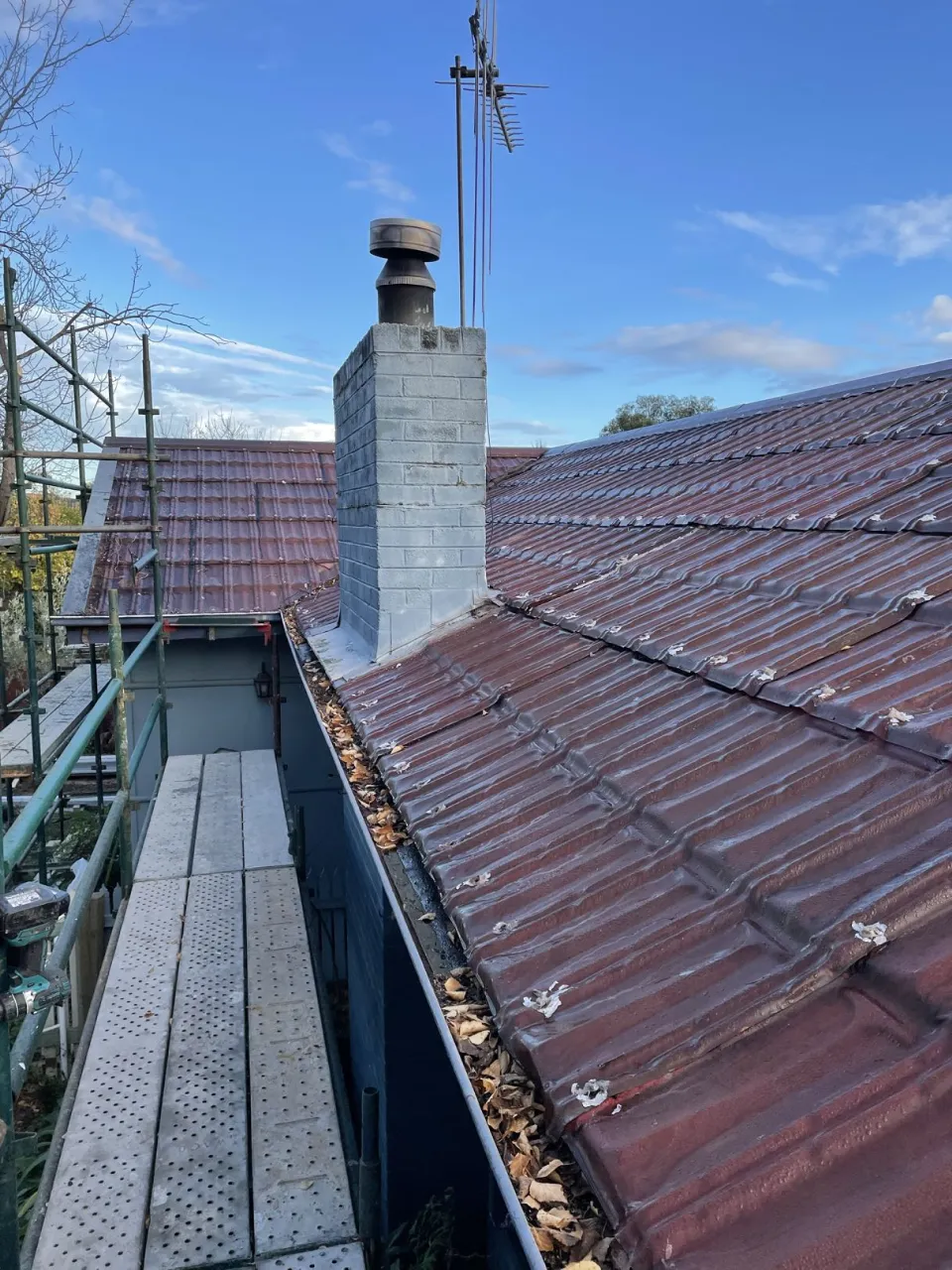 Original aged terracotta tile roof and scaffolding before the full replacement